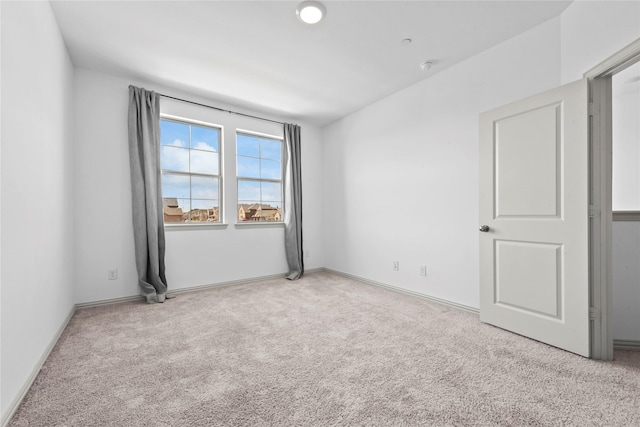 carpeted spare room with baseboards