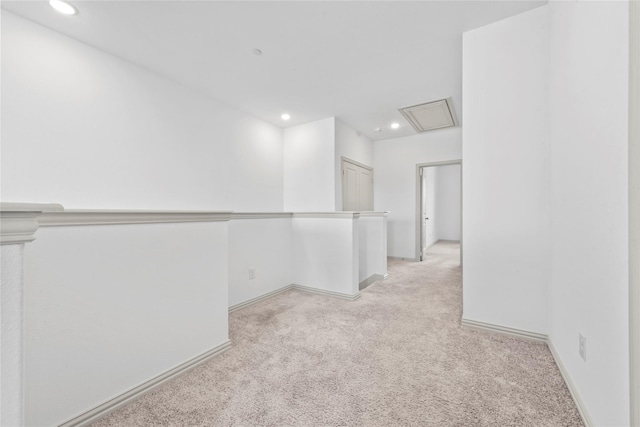 hall featuring recessed lighting, light carpet, and baseboards