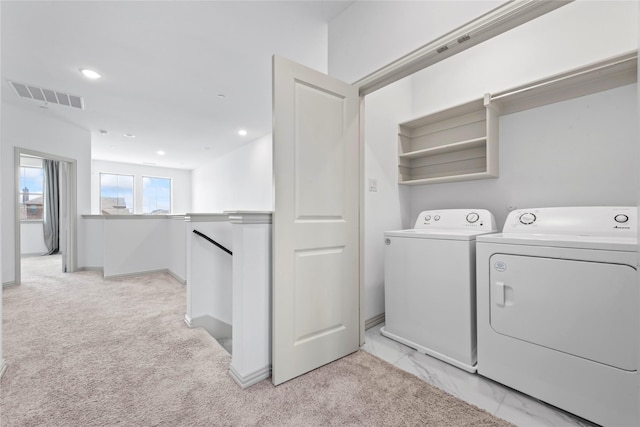 laundry area with laundry area, independent washer and dryer, visible vents, and recessed lighting