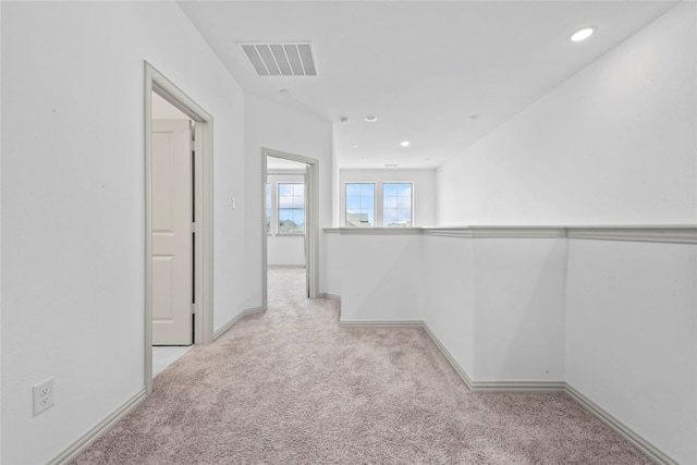 hall with baseboards, visible vents, carpet flooring, and recessed lighting