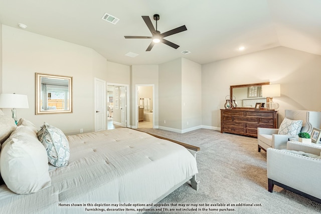 carpeted bedroom featuring lofted ceiling, ceiling fan, visible vents, baseboards, and ensuite bath