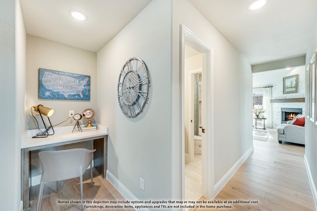 hall featuring recessed lighting, baseboards, and wood finished floors