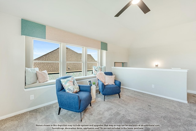 living area with carpet floors, vaulted ceiling, baseboards, and ceiling fan