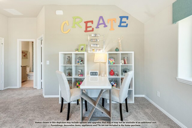 carpeted dining space with lofted ceiling and baseboards