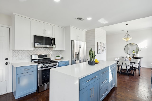 kitchen featuring stainless steel appliances, white cabinetry, light countertops, tasteful backsplash, and dark wood finished floors