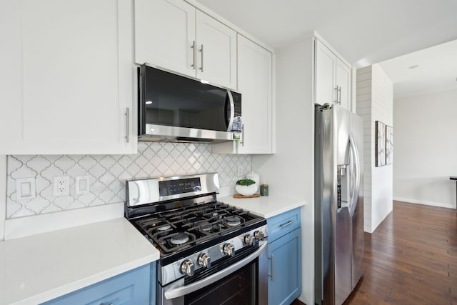 kitchen with stainless steel appliances, white cabinets, light countertops, and backsplash