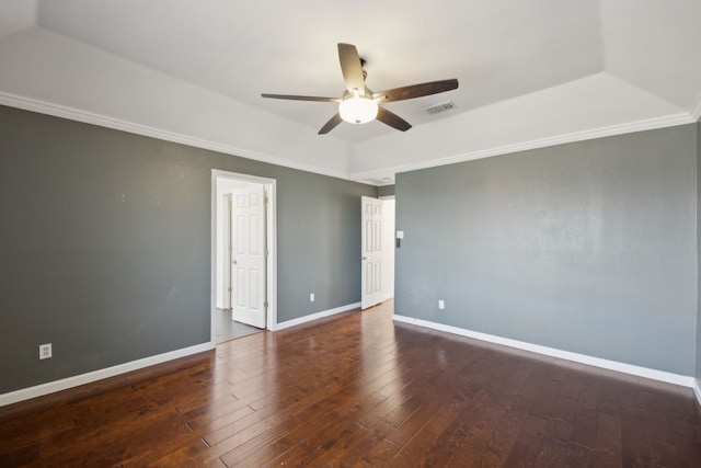 spare room featuring ceiling fan, visible vents, baseboards, hardwood / wood-style floors, and crown molding