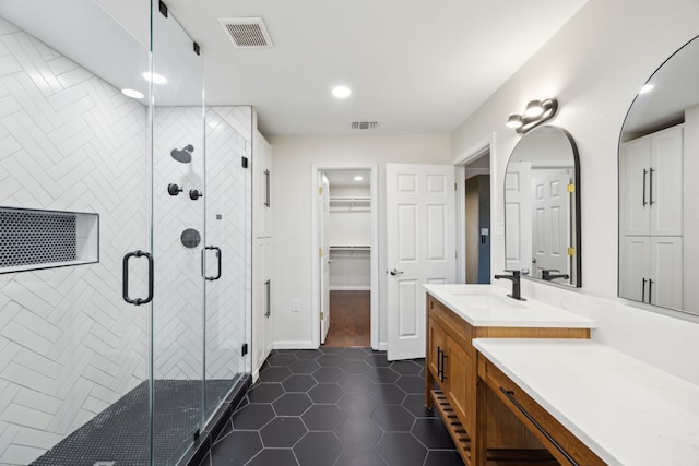 full bathroom featuring a shower stall, vanity, visible vents, and tile patterned floors