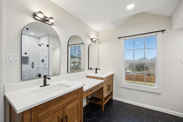 full bathroom with vanity, baseboards, vaulted ceiling, a shower stall, and tile patterned floors