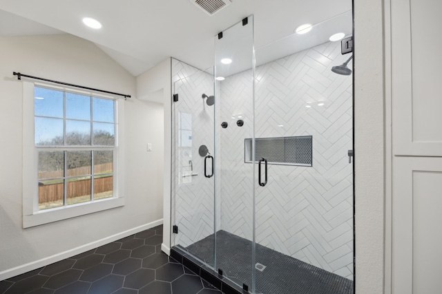 full bath featuring visible vents, baseboards, tile patterned floors, vaulted ceiling, and a shower stall