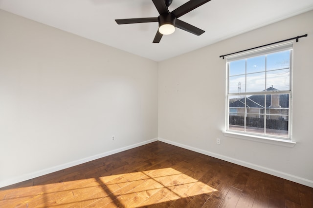 empty room with a ceiling fan, baseboards, and hardwood / wood-style floors