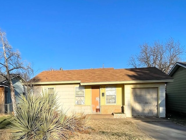 ranch-style house featuring a garage, concrete driveway, and brick siding