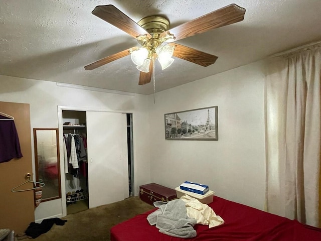 carpeted bedroom featuring a ceiling fan, a closet, and a textured ceiling