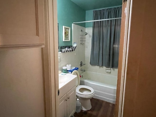 full bath with tub / shower combination, vanity, toilet, and wood finished floors