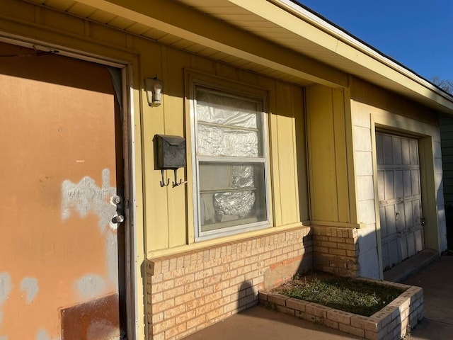 entrance to property featuring brick siding