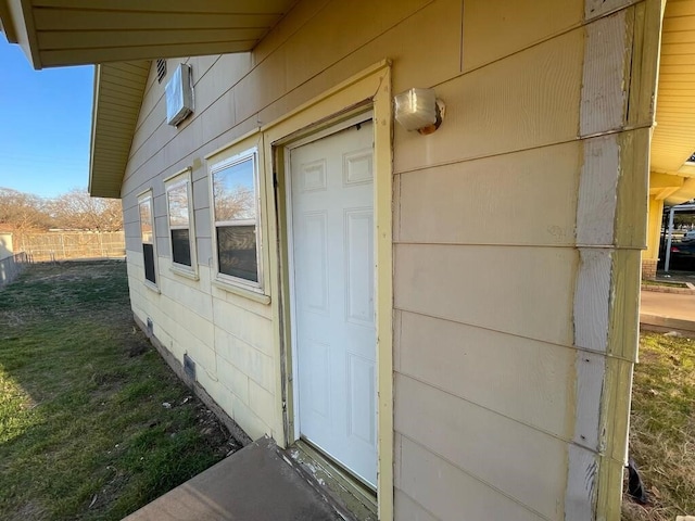 entrance to property with a lawn