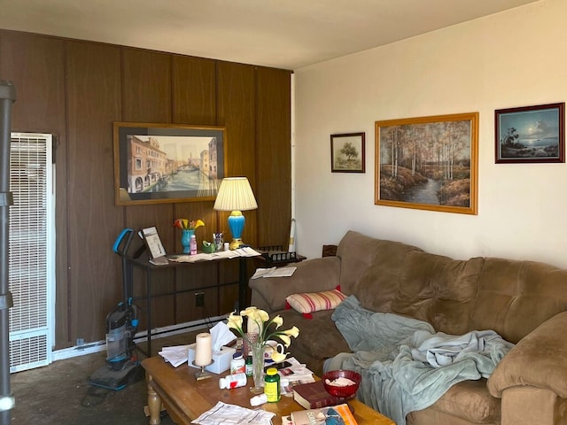 living room featuring wood walls and a heating unit