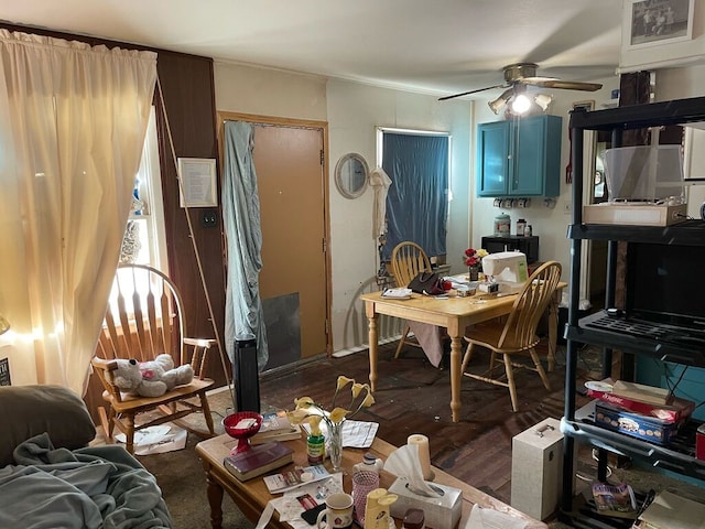 dining area with ceiling fan and dark wood-type flooring