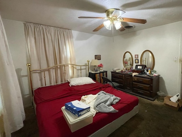 bedroom with ceiling fan, visible vents, and a textured ceiling