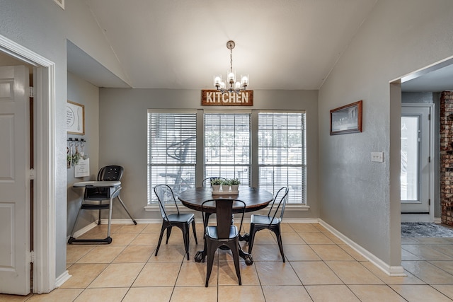 dining room featuring lofted ceiling, baseboards, an inviting chandelier, and light tile patterned floors