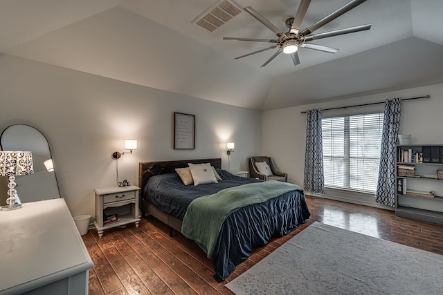 bedroom featuring lofted ceiling, dark wood-style floors, and visible vents