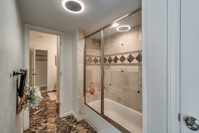 full bath with shower / bath combination with glass door, baseboards, and a textured ceiling