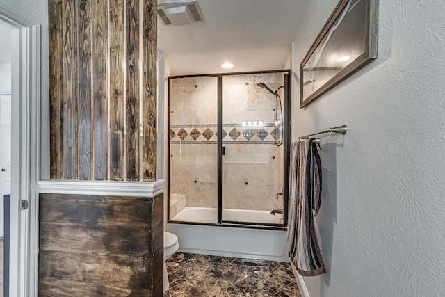 bathroom with toilet, a textured wall, bathing tub / shower combination, and visible vents