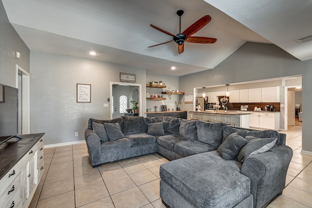 living room with light tile patterned floors, baseboards, visible vents, a ceiling fan, and lofted ceiling