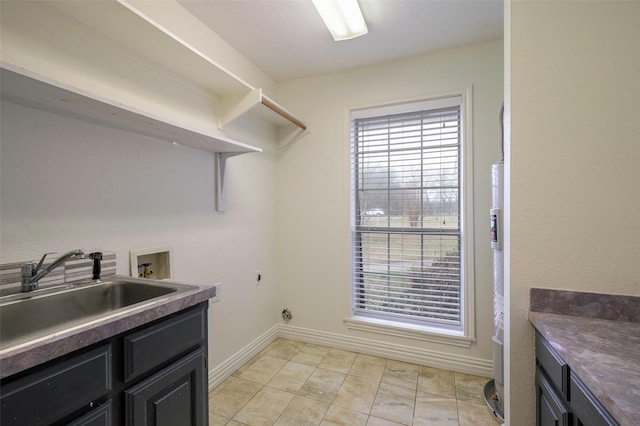 clothes washing area with washer hookup, cabinet space, a sink, and a wealth of natural light