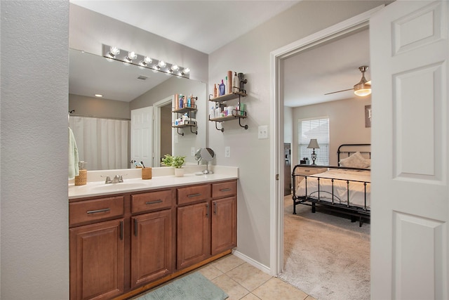 bathroom with ceiling fan, vanity, ensuite bath, baseboards, and tile patterned floors