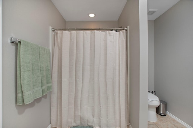 bathroom with a shower with shower curtain, visible vents, toilet, and tile patterned floors