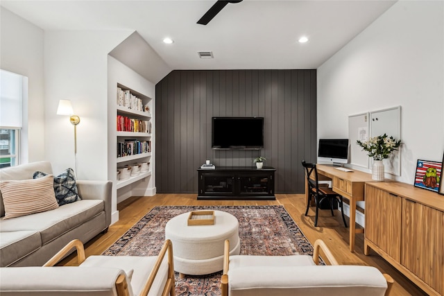 living area with light wood-style flooring, built in shelves, a ceiling fan, and recessed lighting