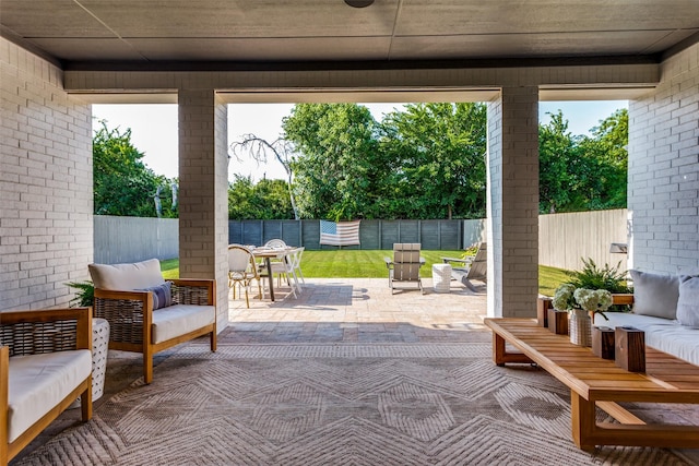 view of patio featuring outdoor dining area, a fenced backyard, and an outdoor living space