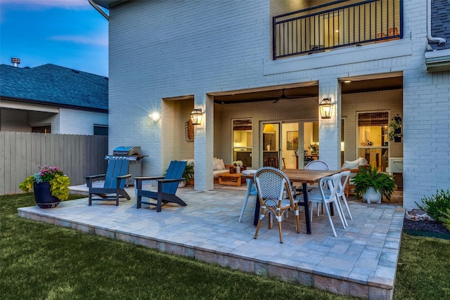 view of patio / terrace with outdoor dining space, a grill, fence, and a balcony