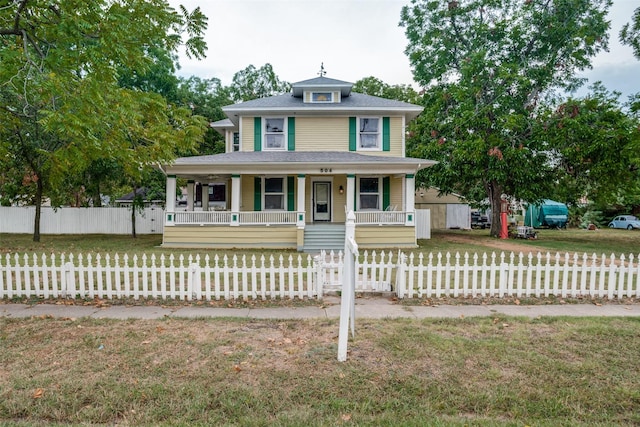 view of front of property featuring a porch, a fenced front yard, and a front lawn