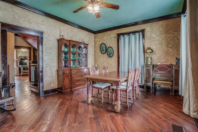 dining space featuring wood-type flooring, visible vents, and crown molding