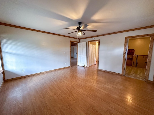 unfurnished bedroom featuring light wood finished floors, baseboards, ceiling fan, ornamental molding, and ensuite bathroom