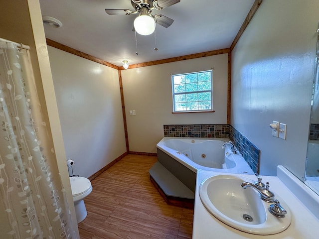 full bathroom featuring a whirlpool tub, wood finished floors, a sink, and crown molding