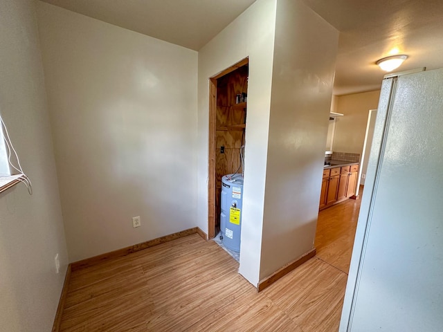 hallway with baseboards and light wood finished floors