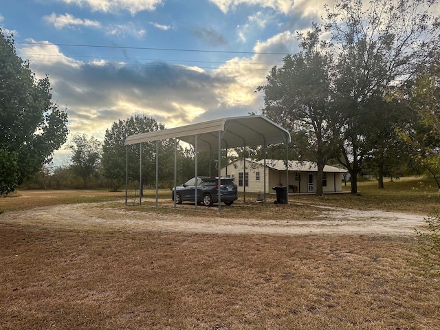 view of yard featuring driveway and a carport