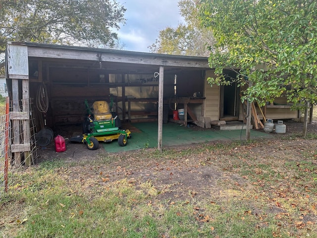 view of outbuilding with a carport and driveway