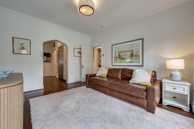 6306 Tremont St, Dallas, TX 75214 - living area featuring arched walkways, crown molding, wood finished floors, and baseboards