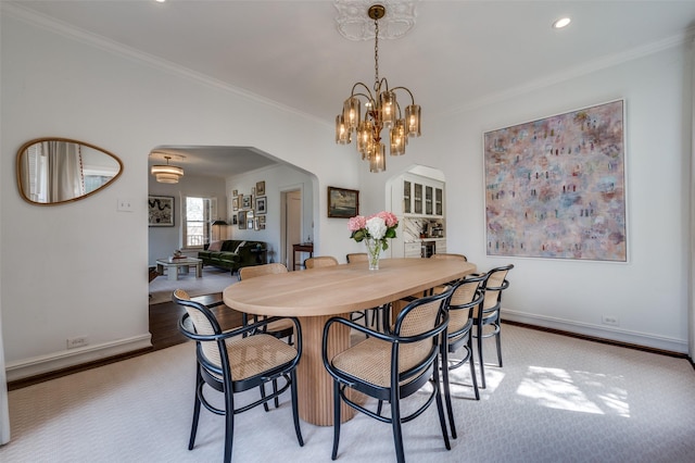 6306 Tremont St, Dallas, TX 75214 - dining area with arched walkways, ornamental molding, baseboards, a chandelier, and recessed lighting