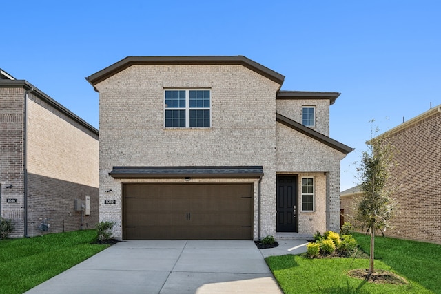 traditional-style house featuring a garage, a front lawn, concrete driveway, and brick siding