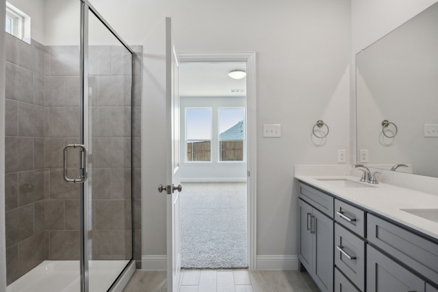 3015 Isla Ter, Princeton, TX 75407 - bathroom featuring a tile shower, double vanity, and baseboards
