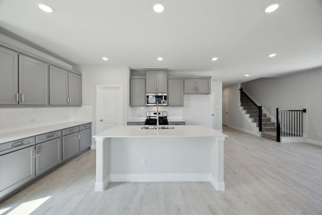 3015 Isla Ter, Princeton, TX 75407 - kitchen featuring appliances with stainless steel finishes, gray cabinets, decorative backsplash, light countertops, and recessed lighting