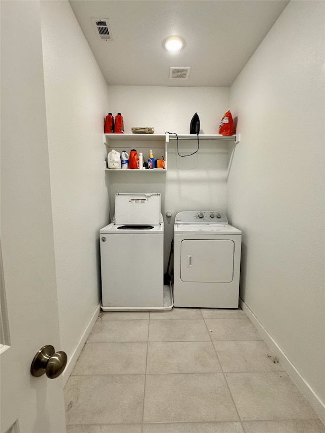 laundry area featuring laundry area, visible vents, baseboards, and separate washer and dryer