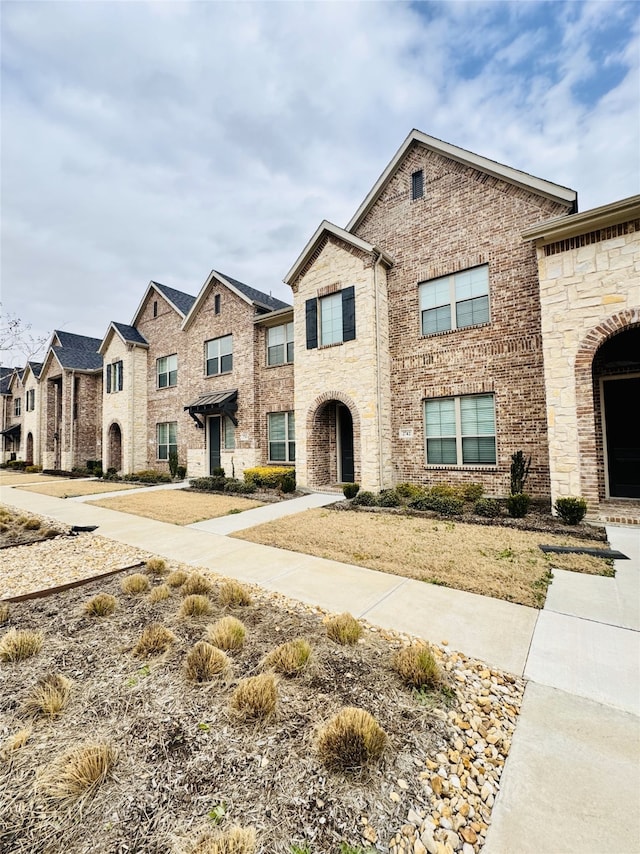 view of front of home featuring brick siding