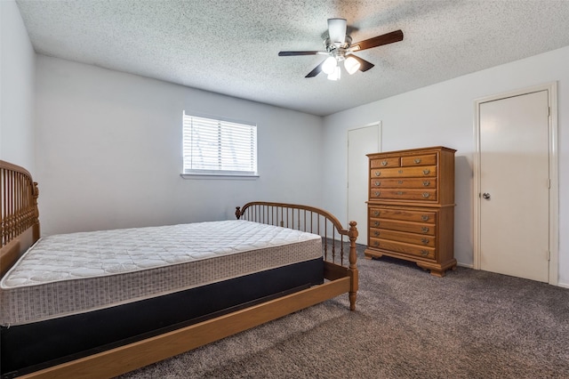 carpeted bedroom with ceiling fan and a textured ceiling