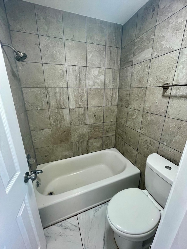 bathroom with marble finish floor, shower / bath combination, and toilet